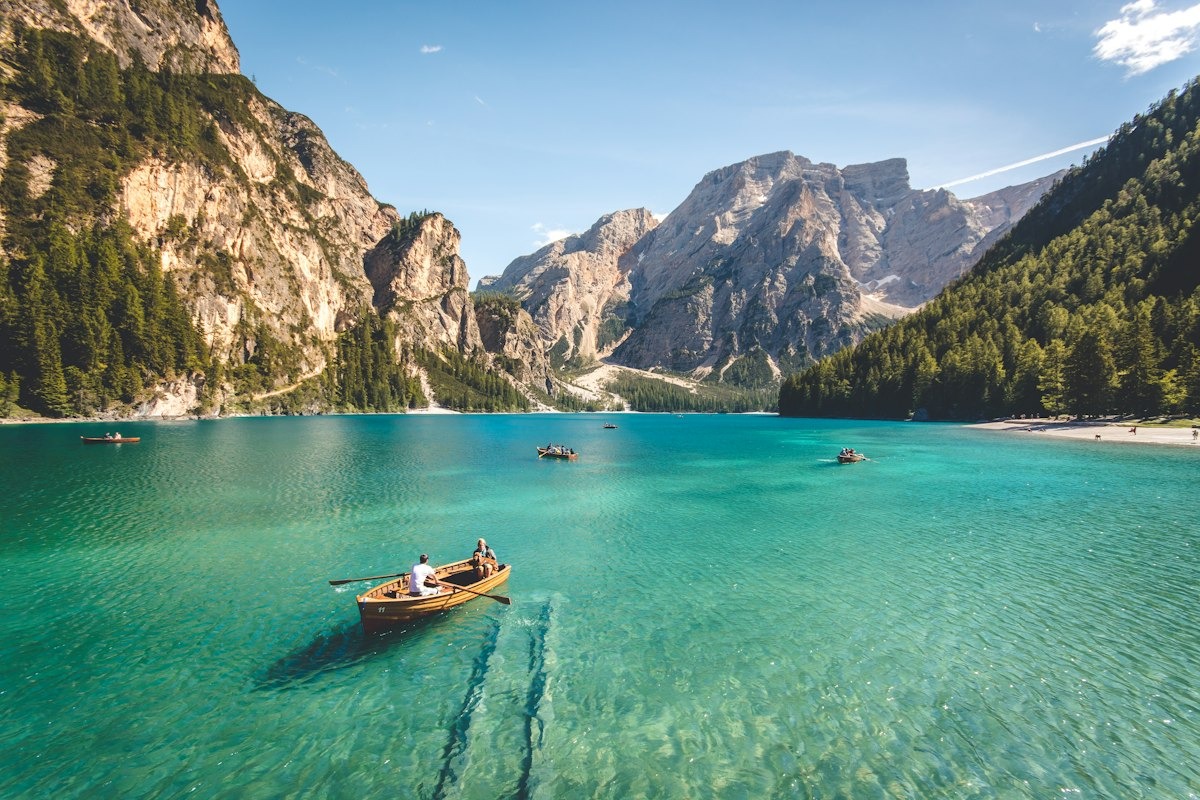 Turquoise alpine lake with a wooden boat