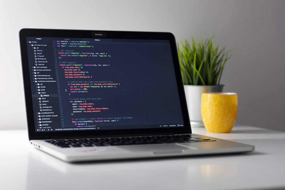 Laptop with code, yellow mug